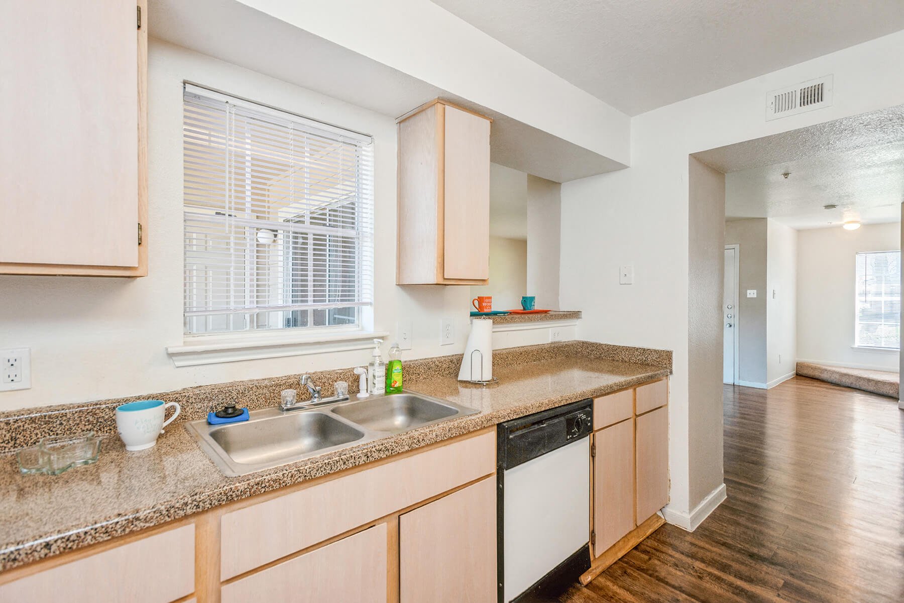 A bright kitchen with hardwood floors at the Park Village Apartments in Conroe, Texas.